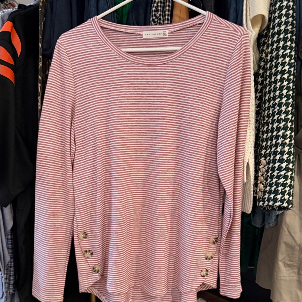 Women’s striped top with button detail.